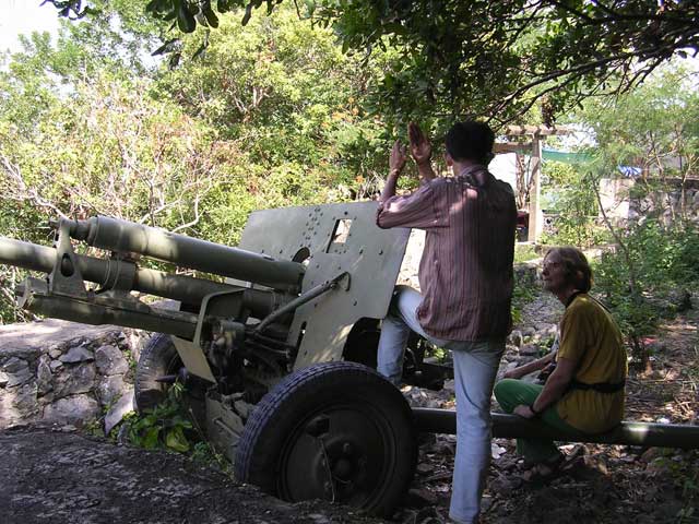 Han Houn explains how the Vietnamese left this field gun behind after they helped Cambodia overthrow the Khmer Rouge