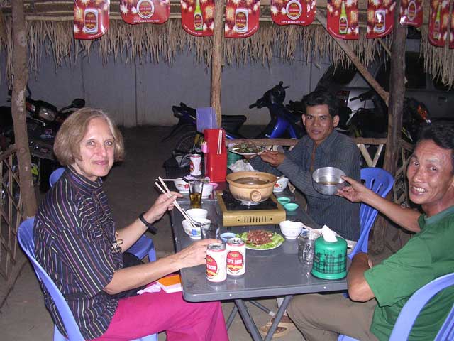 Dinner in Battambang, Cambodia, featuring beef with red ants and 'Cambodian whisky'