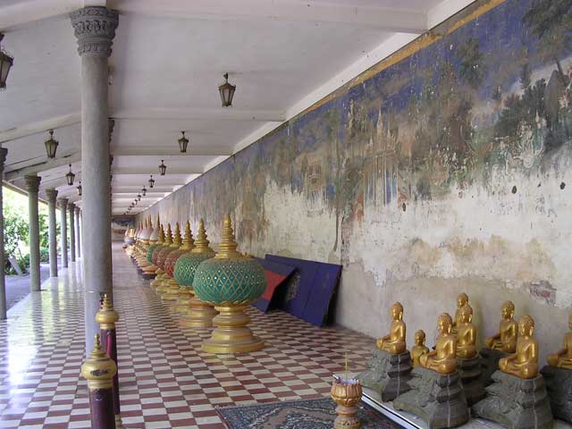 The mural by the exit, with Buddha statues and decorative containers - perhaps for incense?