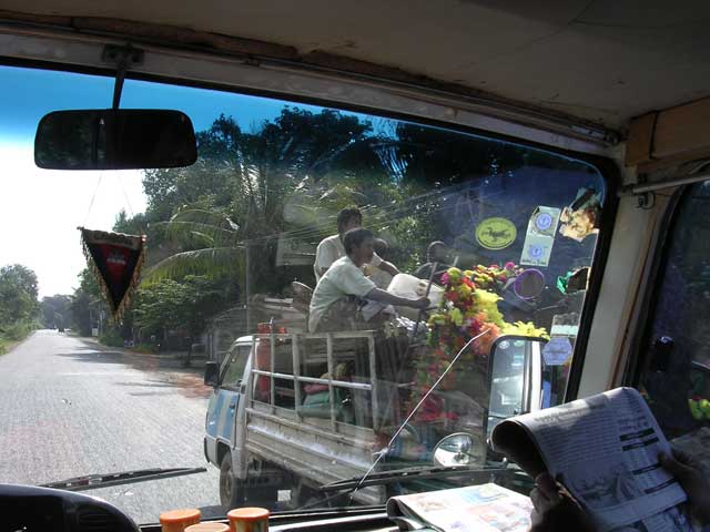 Those are wreaths on the back of the truck - on the way to a funeral?