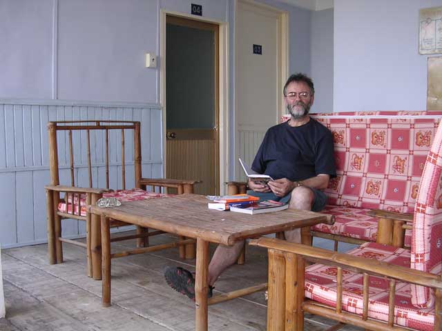 Chris dozes over a book on the veranda