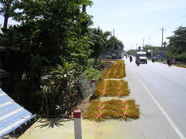 More incense sticks drying by the road