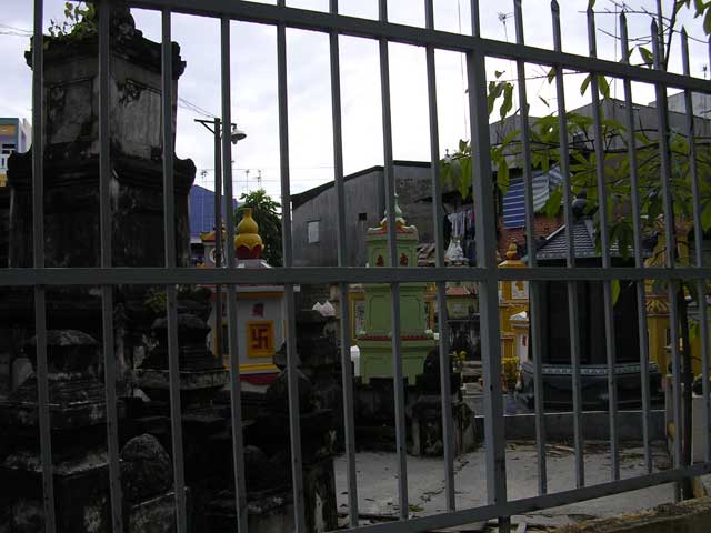 Tombs through the fence, showing a swastika, the 'circle of life'