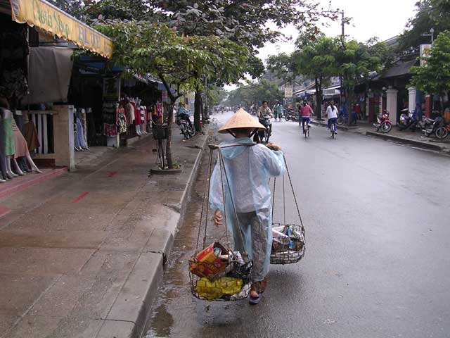 A local rubbish collector - you can see the mannequins in the tailors' shops on the left