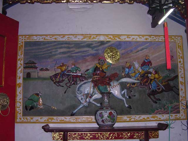 Opposite, a mural of the six Fujian family heads who fled to Hoi An from China in the 17th century