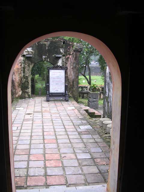 Through the arch at the end, showing one of the beautifully made signs for tourists