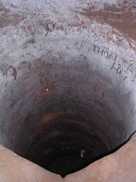 A well, ironically with a Coke can in it