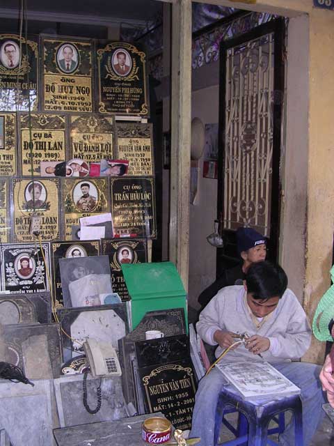 An engraver at work in the street of memorials