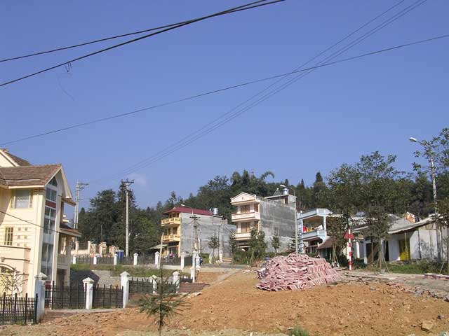 Those are typical Vietnamese houses, with the sides left unpainted ready for the next one to slot in.
