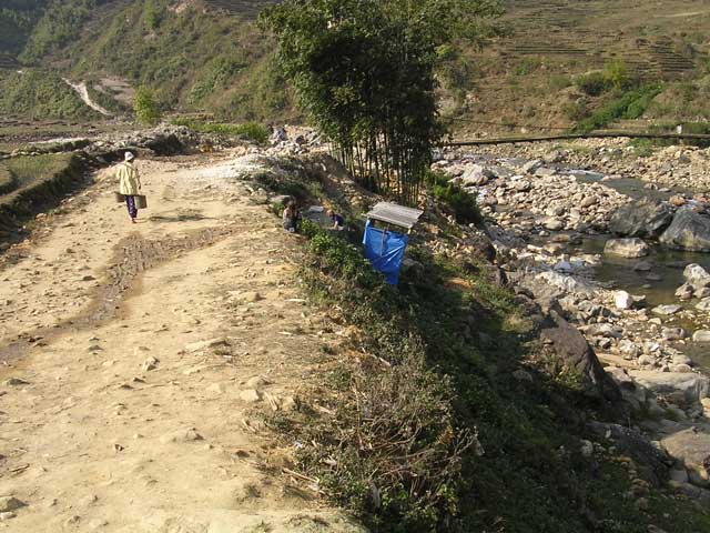 Vietnam: Sapa region - Mary, in a blue top, just visible returning from the loo (the blue plastic thing)