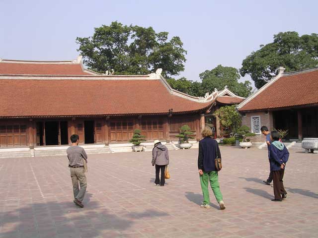 Crossing a courtyard towards a pavilion with a particularly perfect roof