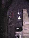 A stupa inside, with some Buddhist flags