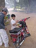 Sambath fills up his moto near Battambang, Cambodia