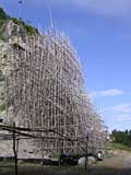 Bamboo scaffolding at the foot of Phnom Sampeau - a huge Buddha is being carved on the side of the hill behind here