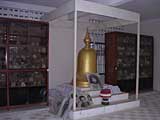A shrine to the victims, with skulls in the cabinets behind