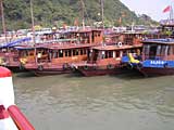 A load of junks at the dock in Ha Long City