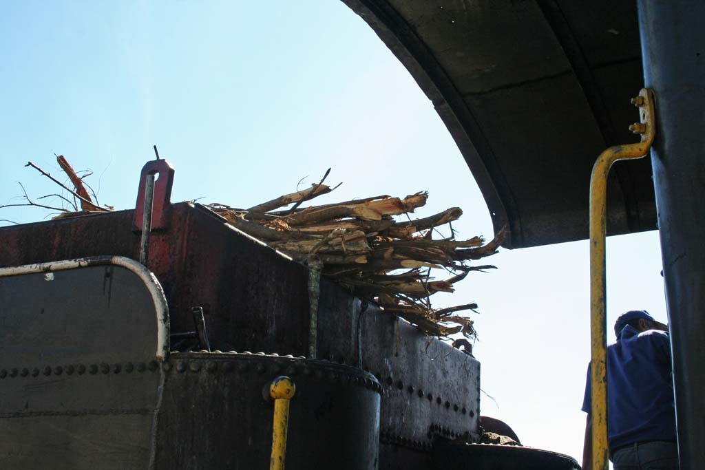 The tender loaded with wood for burning.