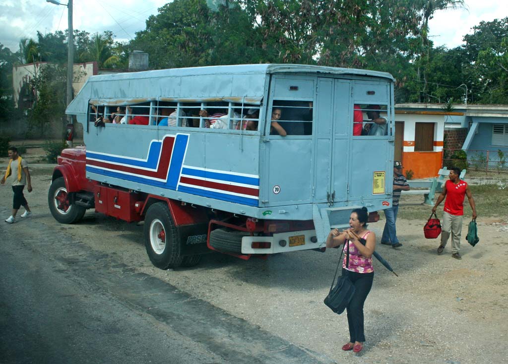 Further on, a passenger truck about to leave, but someone's in great distress.