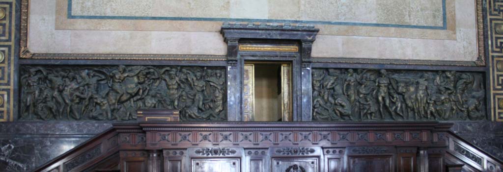 Bronze by Gianni Remussi representing war (L) and workers (R).