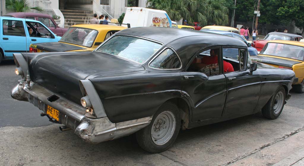 Another old clunker, surrounded by Lada taxis.
