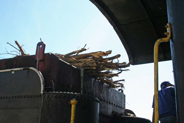 The tender loaded with wood for burning.