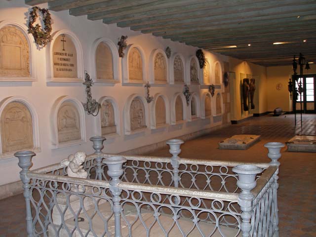 A view along the room containing the coffins and tombstones.
