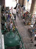 The booksellers take cover under the arcade when it rains.